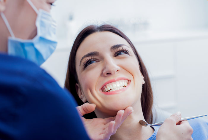 Stock image of a smiling patient in dental chair