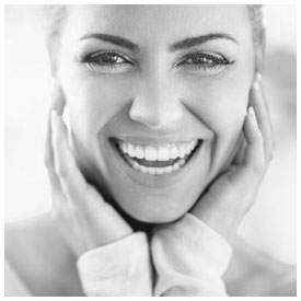 Stock image of a smiling girl holding her face with two hands