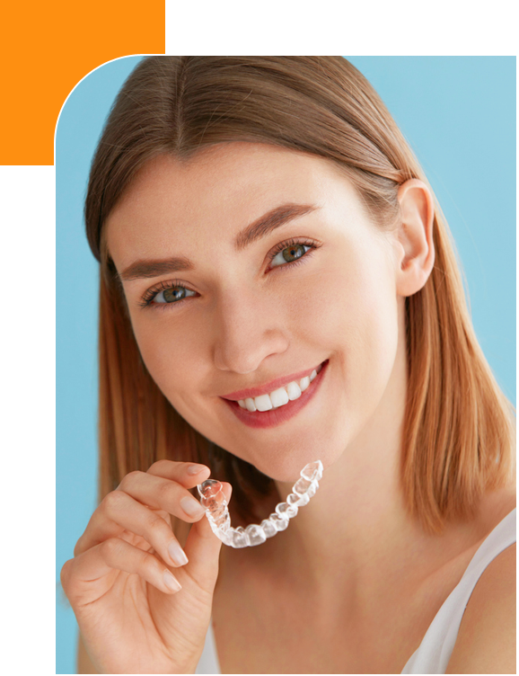 Stock image of a smiling girl holding transparant braces